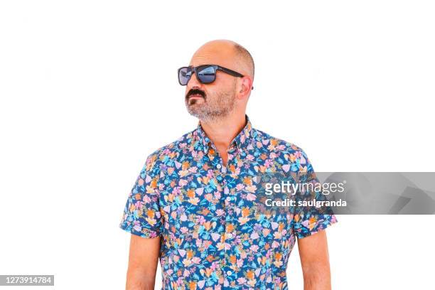 portrait of bald man in floral shirt and sunglasses against white - bald man foto e immagini stock