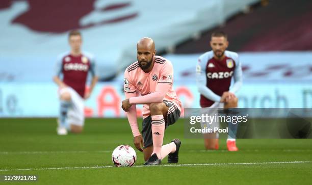 David McGoldrick of Sheffield United takes a knee in support of the Black Lives Matter movement during the Premier League match between Aston Villa...