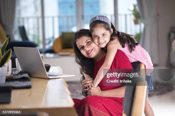 loving daughter embracing mother at home - indian mother and child stock pictures, royalty-free photos & images