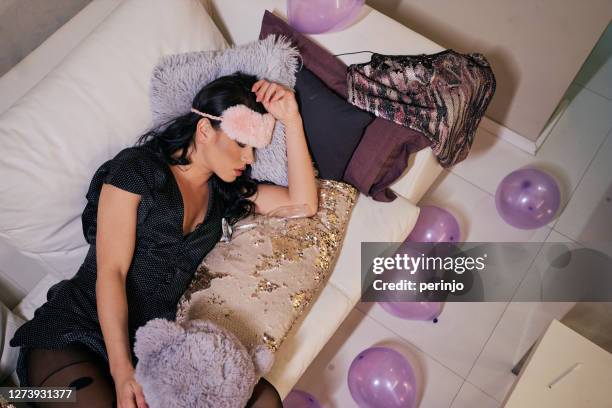 drunk girl sleeping in her clothes near wineglass after birthday party - the morning after stock pictures, royalty-free photos & images
