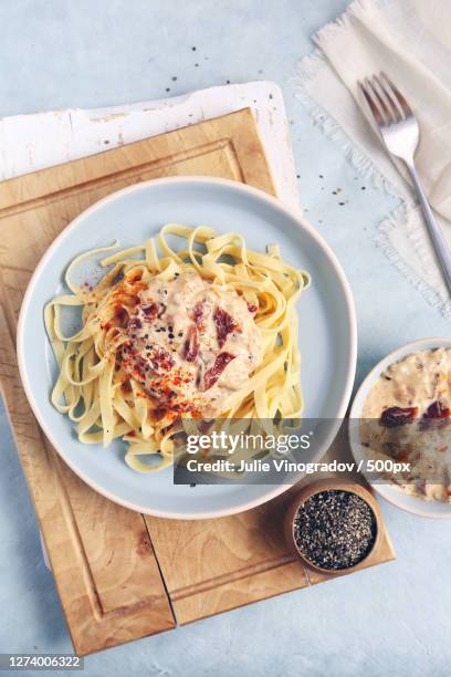 italian tagliatelle with sun-dried tomato cream sauce - pasta tomato basil stock pictures, royalty-free photos & images