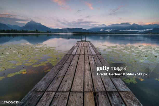 scenic view of lake against sky during sunset, germany - ponton photos et images de collection