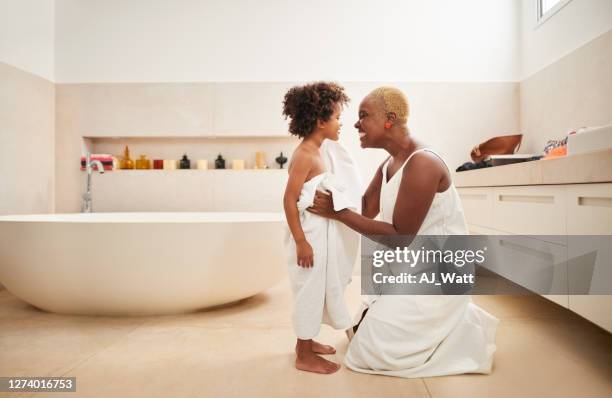 drying off her son after bath - bathroom bathtub stock pictures, royalty-free photos & images