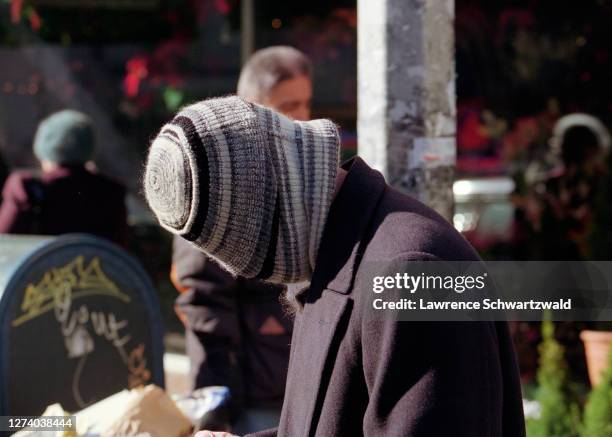 Brad Pitt spotted in a magazine shop on Lexington Avenue, then covers his face with a knit cap when he spots photographers in NYC, December 1, 1995...