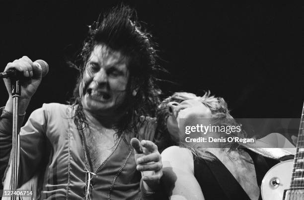 English rock singer Ozzy Osbourne performing with American guitarist Randy Rhoads , circa 1980.