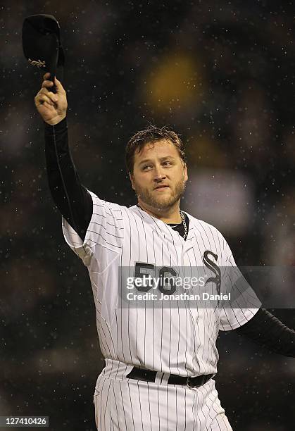 Starting pitcher Mark Buehrle of the Chicago White Sox waves to the crowd after being tasken out of a game against the Toronto Blue Jays at U.S....