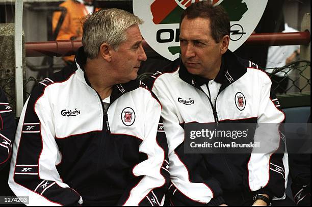 The Liverpool management team of Roy Evans and Gerard Houllier chat on the bench during the pre-season tournament match against Leeds United in...