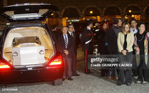 The sister of Luciano Pavarotti and his widow Nicoletta Mantovani stand next to a car carrying his coffin in front of "Duomo di Modena" in the...
