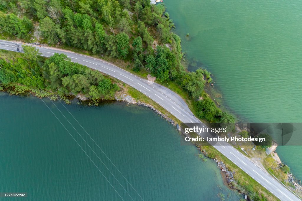 Aerial shot of a road by the water
