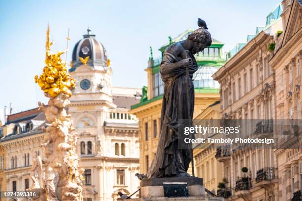 the pestsaule and a statue of a priest near stephan's square - wiener graben stock-fotos und bilder