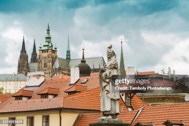 view from charles bridge with statues with the prague castle and st. vitus cathedral in the background - cathedral of st vitus stock pictures, royalty-free photos & images