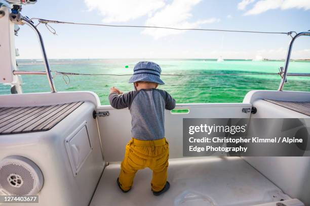 baby playing on sailboat,rottnestisland, western australia, australia - baby boot stock-fotos und bilder