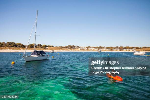 woman kayaking near sailboat, longreach bay, rottnest island, western australia, australia - longreach stock pictures, royalty-free photos & images