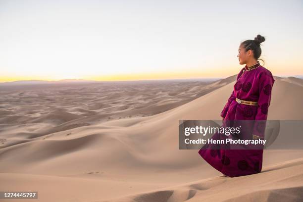 woman admiring gobi desert at sunset, khongor, mongolia - mongolian women stock pictures, royalty-free photos & images