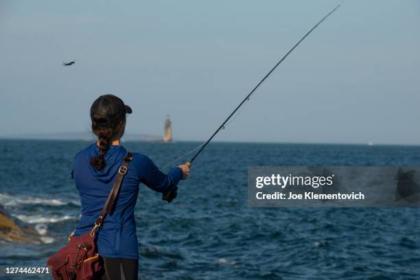 woman fishing on coast, cape elizabeth, maine, usa - cape elizabeth stock pictures, royalty-free photos & images