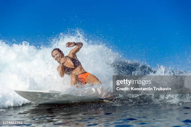 woman surfing in sea, banda aceh, sumatra, indonesia - banda aceh fotografías e imágenes de stock