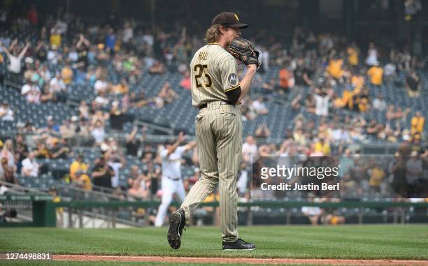 Tim Hill of the San Diego Padres reacts after making a throwing error in the seventh inning during the game against the Pittsburgh Pirates at PNC...