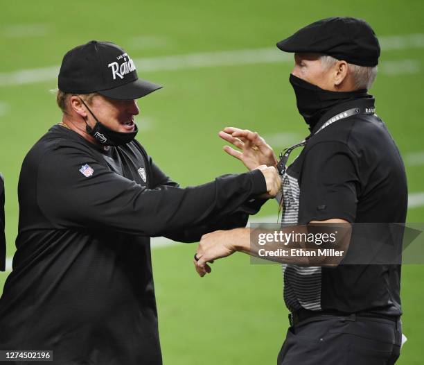 Head coach Jon Gruden and general manager Mike Mayock of the Las Vegas Raiders celebrate on the field after the Raiders defeated the New Orleans...