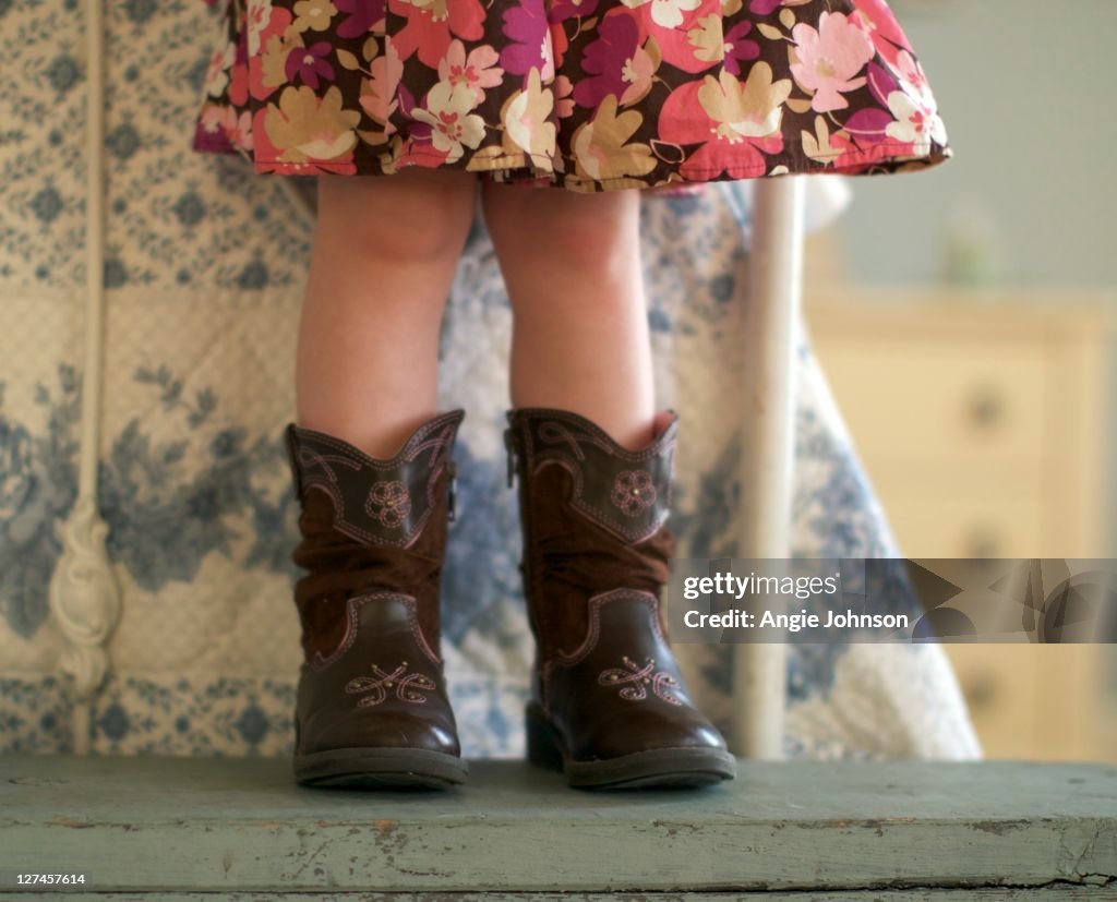 Small girl standing on bench