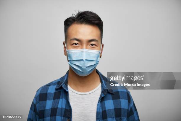 chinese businessman wearing face mask on white background - man studio shot stock pictures, royalty-free photos & images