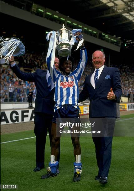 From left to right George Curtis, Dave Bennett and John Sillett of Coventry celebrate with FA Cup trophy after beating Tottenham Hotspurs at Wembley...