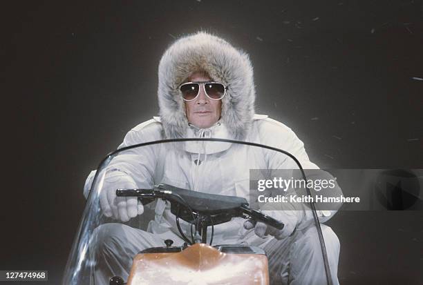 Matte shot of English actor Roger Moore as 007, driving a snowmobile in a publicity still for the James Bond film 'A View To A Kill', 1984. The...