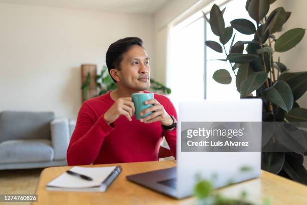 man taking a break while working from home - café rouge photos et images de collection