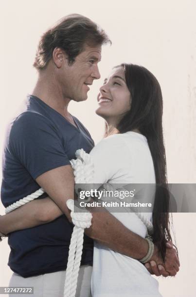 English actor Roger Moore as 007 with French actress Carole Bouquet as Melina Havelock on the set of the James Bond film 'For Your Eyes Only', 1981....