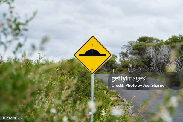 a yellow speed hump sign in the bush - speed bump stock pictures, royalty-free photos & images