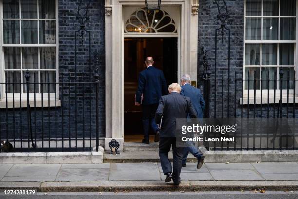 Britain's Prime Minister Boris Johnson enters number 10 with Chief Medical Officer Chris Whitty and Chief Scientific Officer Patrick Vallance...