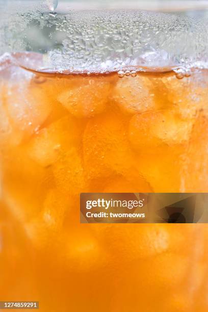 close up of a glass or iced red apple juice. - dew texture stock pictures, royalty-free photos & images