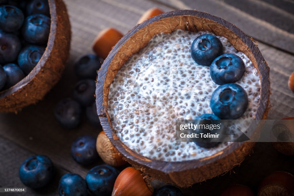 Chia Pudding, blackberry and hazelnut in coconut shell