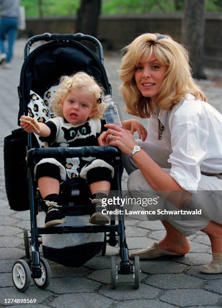 Marla Maples, then wife of Donald Trump, and daughter, Tiffany Trump in stroller on Fifth Avenue after a stroll in Central Park, NYC. Exclusive.