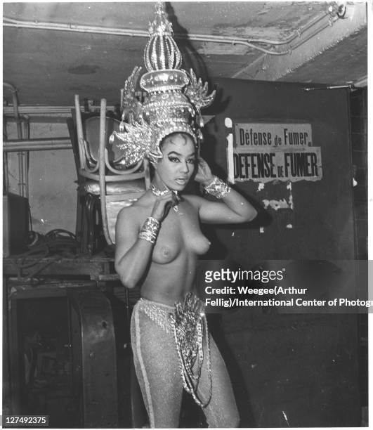 Portrait of a showgirl in a massive headdress backstage,mid 20th century.