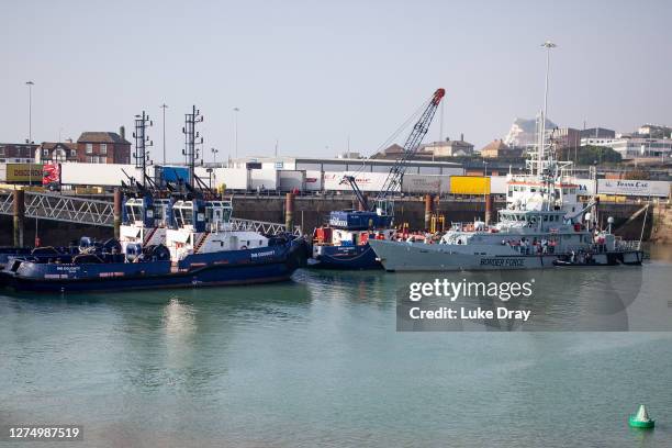 Border Force officials unload migrants, that have been intercepted in the English Channel, in order to process them on September 22, 2020 in Dover,...