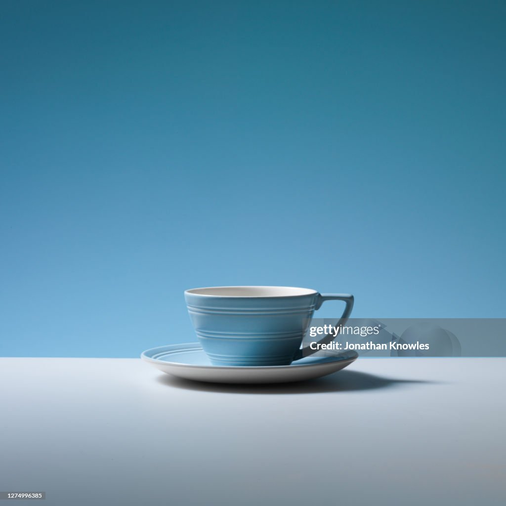 Empty blue coffee cup and saucer