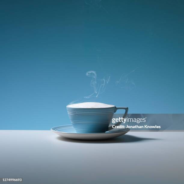 steaming cappuccino in blue cup - steam stock pictures, royalty-free photos & images