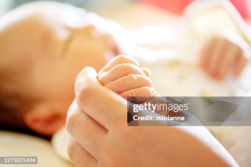 Holding Hands. hand the newborn baby in the hand of parent. Holding Hands. hand the newborn baby in the hand of parent.