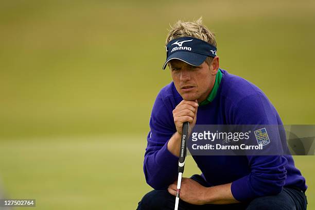 Luke Donald of England plays a shot during the first round of the 2011 Open Championship at Royal St. George's Golf Club in Sandwich, England on July...