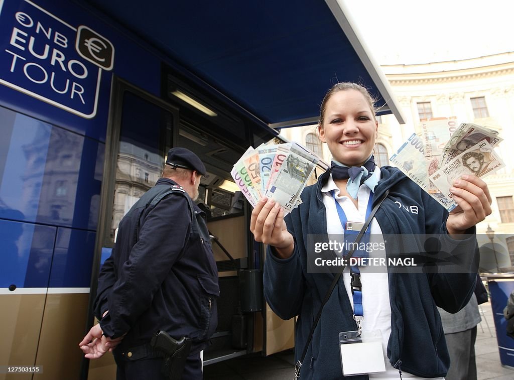 A woman holds Euro currency in her right