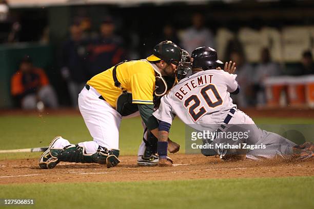 Landon Powell of the Oakland Athletics tags out Wilson Betemit of the Detroit Tigers out at home at the Oakland-Alameda County Coliseum on September...