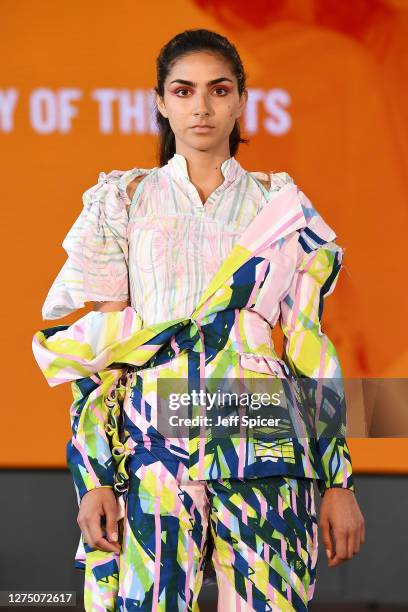 Model, wearing designs by Alice Fox from Norwich University of the Arts, walks the runway during the Graduate Fashion week show during LFW September...