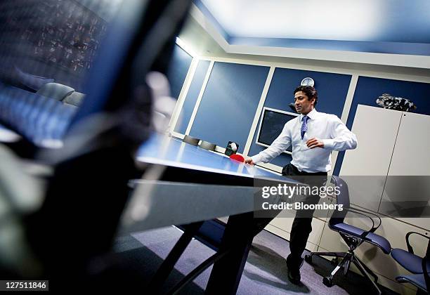 Vinayak Singh, president of ISI Group Inc., plays table tennis in the company's conference room in New York, U.S., on Thursday, Sept. 15, 2011....