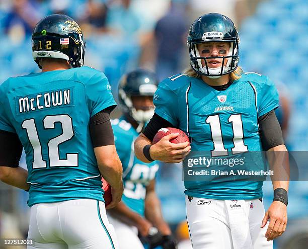 Quarterbacks Blaine Gabbert and Luke McCown of the Jacksonville Jaguars warm up prior to the game against the Carolina Panthers at Bank of America...