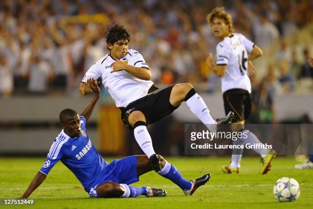 Ever Banega of Valencia is tackled by Ramires of Chelsea during the UEFA Champions League Group E match between Valencia CF and Chelsea at the...