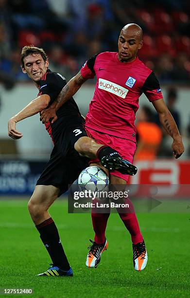 Stefan Reinartz of Leverkusen challenges Marvin Ogunjimi of Genk during the UEFA Champions League group E match between Bayer 04 Leverkusen and KRC...