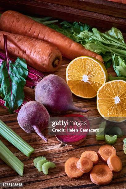 carrots, beetroot and orange fruit on old wooden board ready to cook - carrot juice stock pictures, royalty-free photos & images