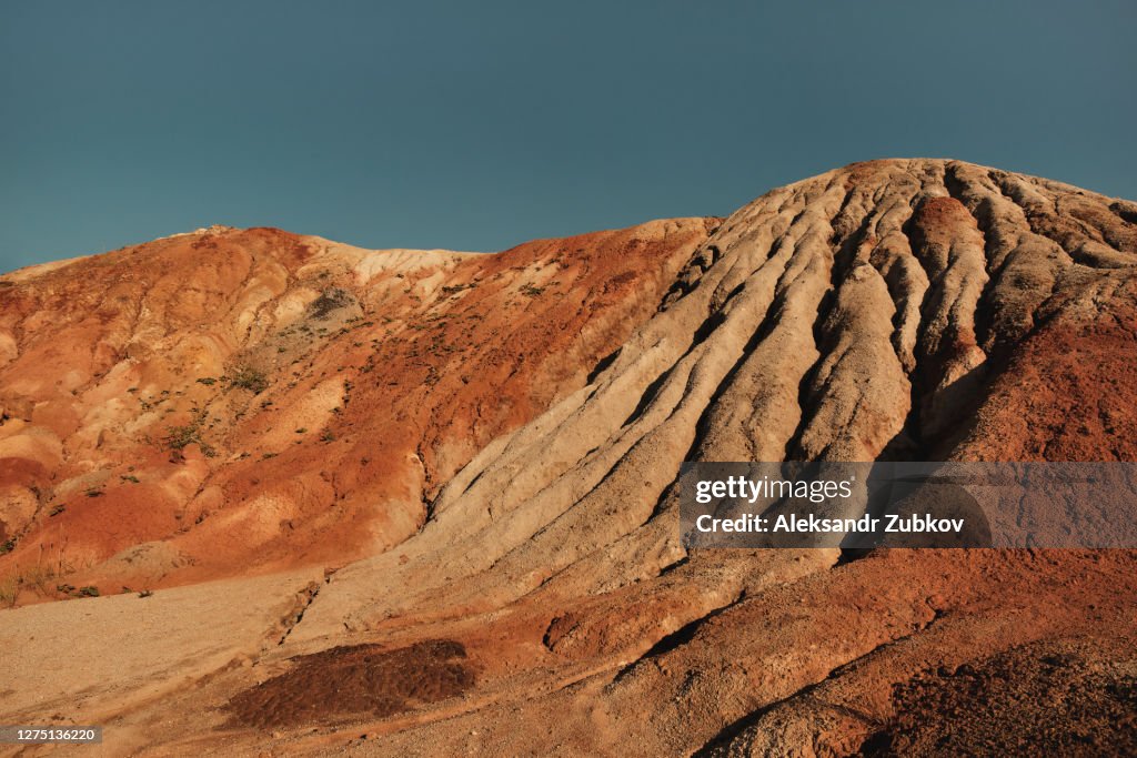 Ural Apocalyptic Surreal unusual landscape, similar to the surface of the planet Mars. Frozen red-brown surface of Chernozem. Barren, cracked and scorched earth and soil. The concept of global warming. Refractory clay quarries. Textured background.