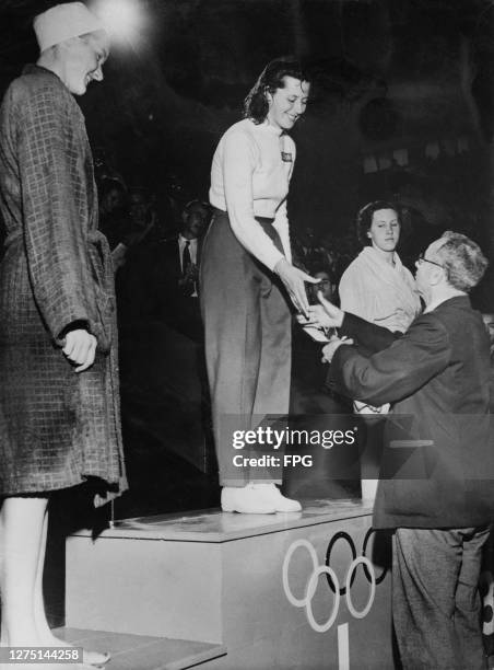 American swimmer Ann Curtis , Danish swimmer Greta Andersen, being presented with her gold medal by President of the International Swimming...