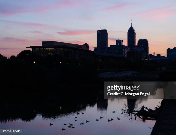 The NCAA National Office and NCAA Hall of Champions sits on the White River in front of the silhouetted Indianapolis skyline on September 22, 2020 in...